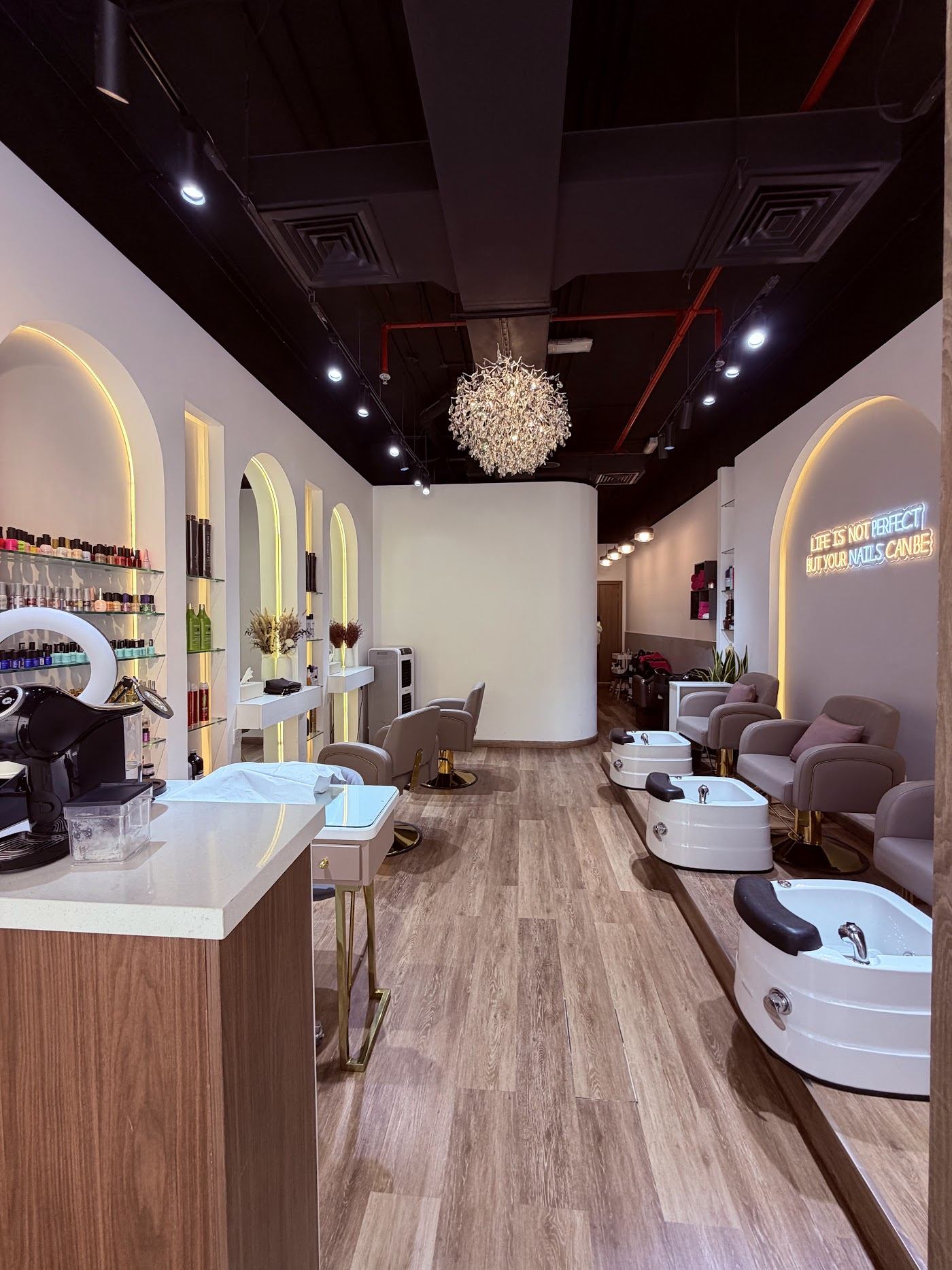 Inside Ash Beauty: arched shelves, chandelier and pedicure lounge
