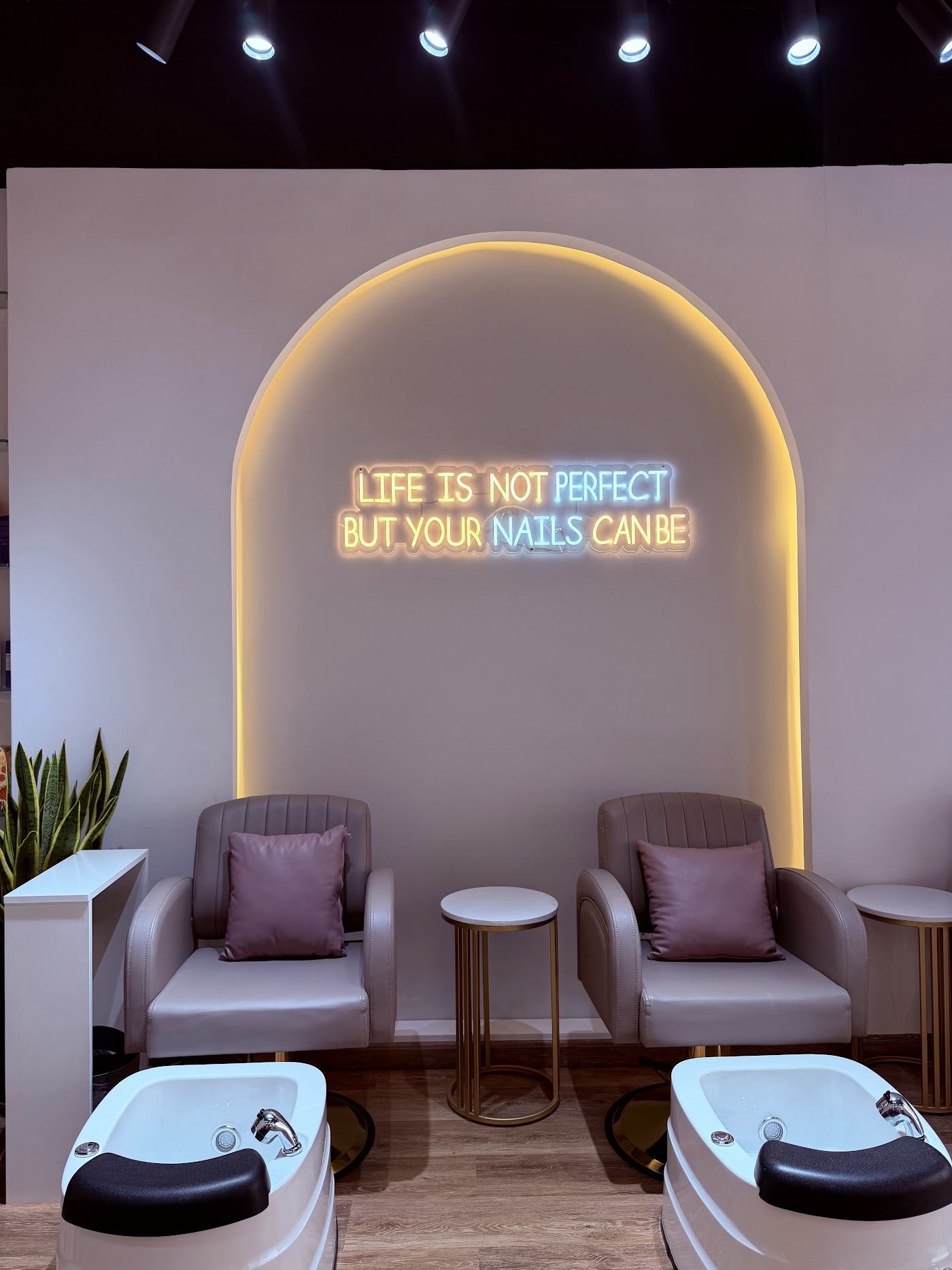 Pedicure lounge with neon sign: Life is not perfect but your nails can be